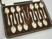 A set of twelve Old English pattern silver teaspoons and matching sugar tongs