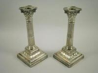 A pair of silver Corinthian column candlesticks