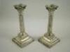 A pair of silver Corinthian column candlesticks