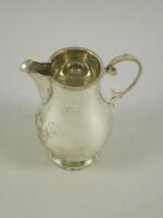 A silver baluster shaped cream jug