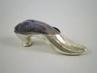 A silver and velvet pin cushion in the form of a shoe