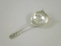 A silver tea strainer