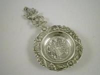 A Dutch white metal tea strainer