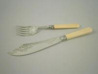 A pair of silver and ivory fish servers