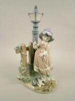 A Lladro figure of a young girl sweeping