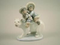 A Lladro figure of two children sat on a polar bear