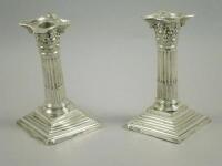 A pair of silver Corinthian column candlesticks