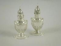 A pair of silver part fluted pepper pots