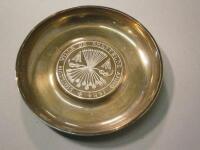 A modern silver circular pin tray