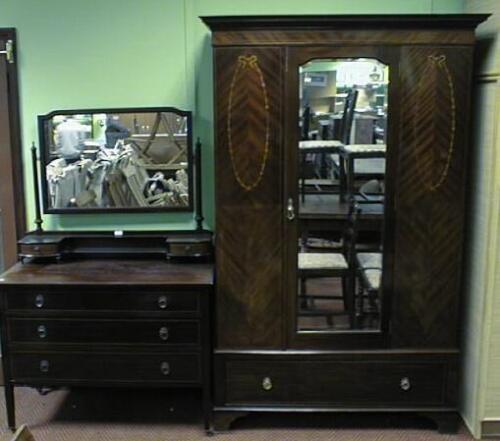 An Edwardian quarter veneered mahogany wardrobe with floral marquetry