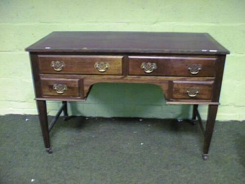 An Edwardian mahogany writing table with leather inset top