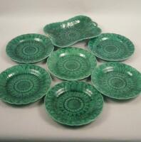 A collection of seven green leaf moulded plates