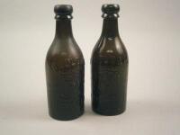 Two similar brown glass bottles