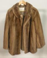 A fur coat bearing the label for Dyson furriers of Leeds.