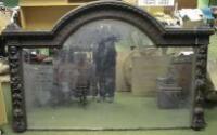 A mid Victorian carved oak overmantel mirror with arch top having egg