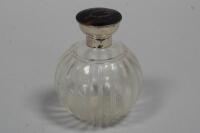 A silver and tortoiseshell topped globe shaped cut glass scent bottle