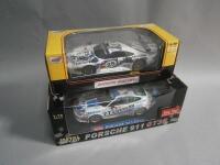 Two 1:18 scale die cast Porsche GT Racers.