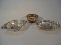 A Victorian silver semi fluted bowl and two silver bonboniere baskets