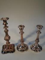 A pair of old Sheffield plated candlesticks and another