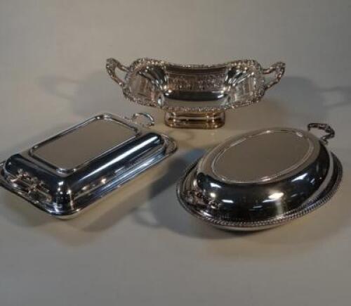 A silver plated bread basket and two entree dishes. (3).