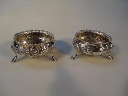 A matched pair of Victorian silver circular salts one by Robert Hennell