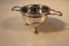 A George V silver tea strainer and base by Walker and Hall