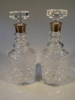 A pair of modern cut glass and silver collared decanters