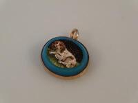 A micro mosaic pendant depicting a recumbent spaniel in yellow metal frame.