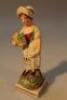 An early 19thC creamware figure of harvester