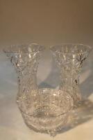 A pair of large cut glass flower vases and a cut glass fruit bowl.