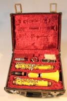 A Boosey & Hawkes yellow clarinet in case.