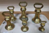 Six brass bell weights.