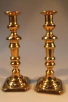 A pair of turned brass candlesticks.