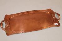 A hammered copper Art Nouveau style serving tray 85cm long.