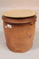 A terracotta bread bin with wooden lid