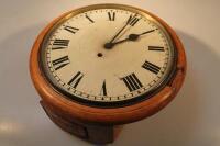 An oak cased circular wall clock