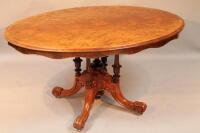 A Victorian oval walnut veneered breakfast table