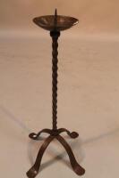 A cast metal pricket candlestick