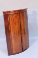 An 18thC oak and mahogany veneered bow fronted corner cabinet