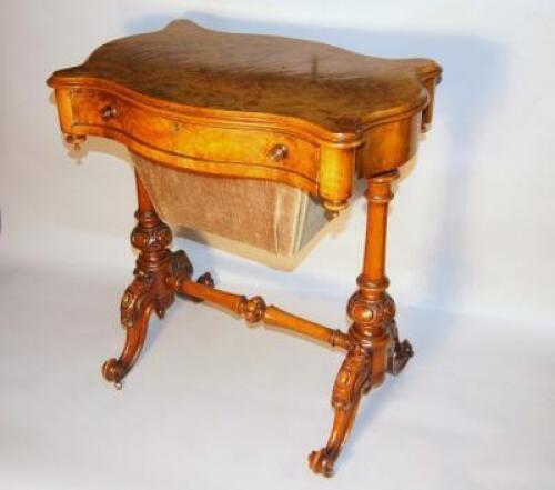 A Victorian walnut sewing table