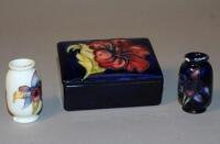 A Moorcroft 'Anemone' pattern trinket box and two miniature Moorcroft vases.