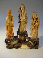 A Chinese carved hardstone figure group of three Taoist immortals