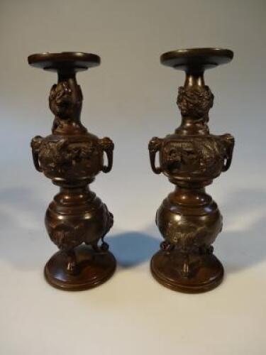 A pair of Japanese 20thC cast metal candlesticks