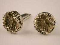 A pair of silver cuff links