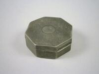 An octagonal silver pill box