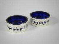 A pair of pierced silver open salt cellars