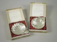 A pair of modern Elizabeth II silver shell shaped butter dishes in Georgian style