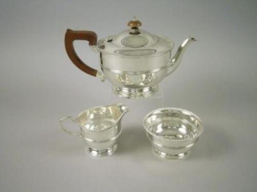 A silver three piece tea set
