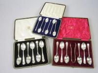 Three sets of cased silver spoons