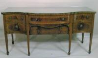 A mahogany serpentine fronted sideboard in George III style